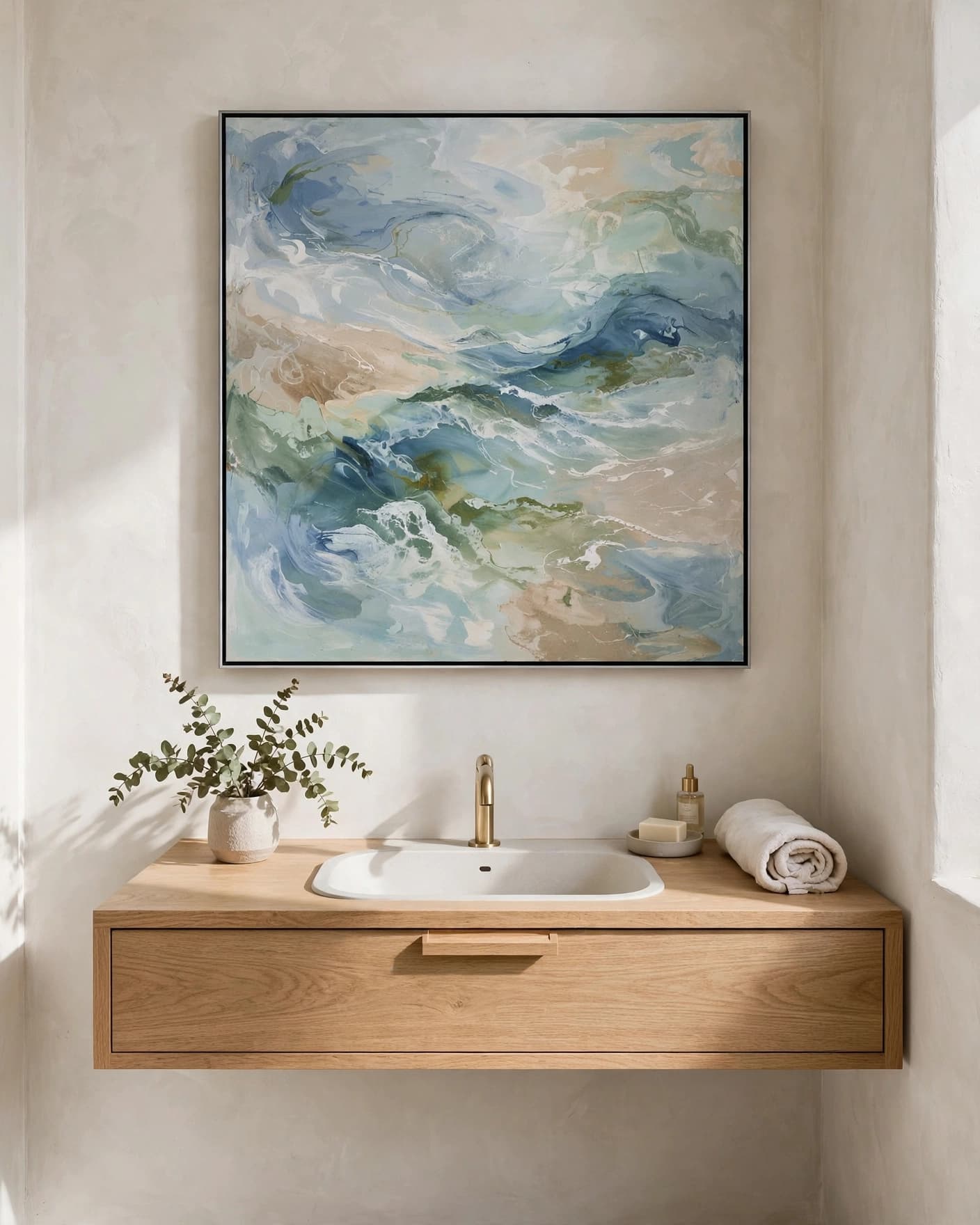 A small bathroom with coastal artwork above a floating oak vanity.